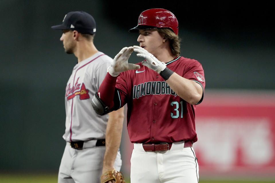 Arizona Diamondbacks' Jake McCarthy motions towards his dugout after a base hit against the Atlanta Braves during the second inning of a baseball game, Thursday, July 11, 2024, in Phoenix. (AP Photo/Matt York)