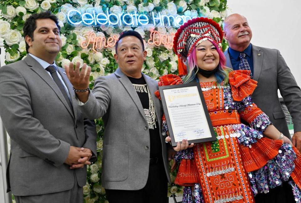 Fresno Councilman Mike Karbassi, left, The Fresno Center CEO Pao Yang, second from left, Renee Ya from Tiger Byte Studios and Fresno Mayor Jerry Dyer pose for a photo as Renee Ya holds the proclamation at the 2023 Hmong American Day celebration Saturday, May 13, 2023 in Fresno. The event which included a ramen bar, music and fashion featured a proclamation by Fresno Mayor Jerry Dyer recognizing Hmong American Day and the history and contributions of the Hmong to the Valley.