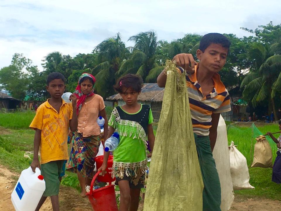 Rohingya refugees walk from the Myanmar border to Kutupalong refugee camp in Bangladesh