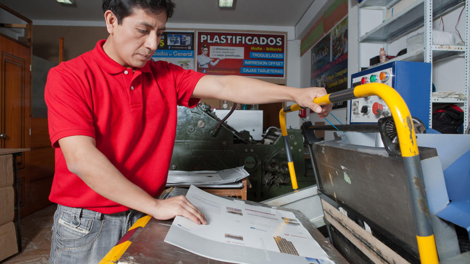 Man works in an offset printing machine.