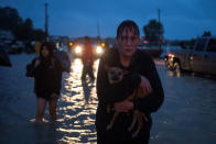 <p>A woman holds her dog as she arrives to high ground after evacuating her home due to floods caused by Tropical Storm Harvey along Tidwell Road in east Houston, Texas, Aug. 28, 2017. (Photo: Adrees Latif/Reuters) </p>