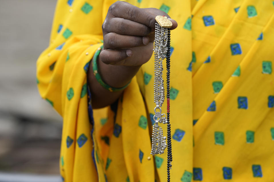 A neighbour displays the half-charred anklet that Khushboo Bind was wearing when a lightning struck and killed her in a paddy field on July 25, at Piparaon village on the outskirts of Prayagraj, in the northern Indian state of Uttar Pradesh, Thursday, July 28, 2022. Seven people, mostly farmers, were killed by lightning in a village in India's northern Uttar Pradesh state, police said Thursday, bringing the death toll by lightning to 49 people in the state this week. (AP Photo/Rajesh Kumar Singh)