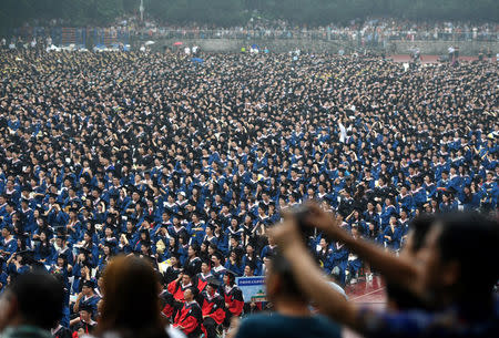 Students wearing academic gowns attend their graduation ceremony at Wuhan University in Hubei province, China June 22, 2018. REUTERS/Stringer