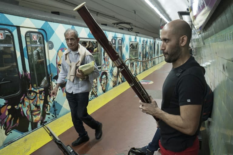 Bassoon player Cesar Perez plays a cross-platform subway duet with violinist Fedosky Suarez