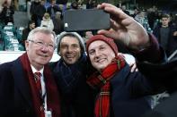 Football Soccer - VfL Wolfsburg v Manchester United - UEFA Champions League Group Stage - Group B - Volkswagen-Arena, Wolfsburg, Germany - 8/12/15 Fans take a selfie with Sir Alex Ferguson while being held in the stadium after the game due to a security alert Action Images via Reuters / Carl Recine Livepic EDITORIAL USE ONLY.
