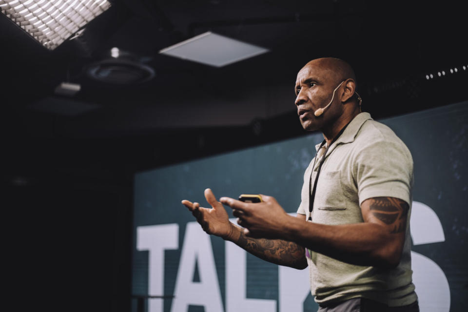 Male speaker at a technology conference.Photo: Black male speaker