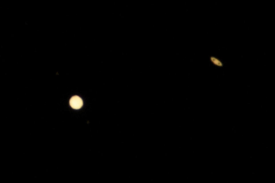 Planets Jupiter (L) and Saturn are seen from the Griffith Observatory on December 21, 2020, in Los Angeles, California. / Credit: PATRICK T. FALLON/AFP via Getty Images