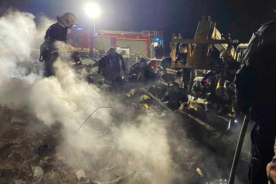 Emergency services work at the scene of a building that was damaged by a Russian drone attack in Vinnytsia, Ukraine (AP)