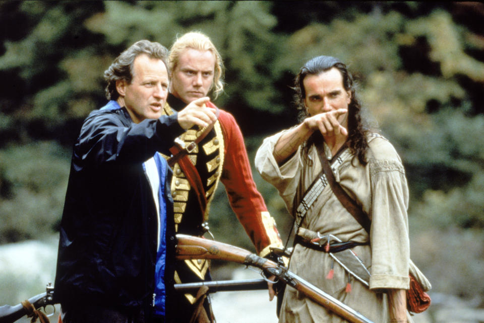 American filsm director Michael Mann (left) points into the distance as he rehearses a scene with British actors Steven Waddington (center) and Daniel Day-Lewis during the filming of 'Last of the Mohicans,' North Carolina, 1992. (Photo by Fotos International/Frank Connor/Getty Images) 