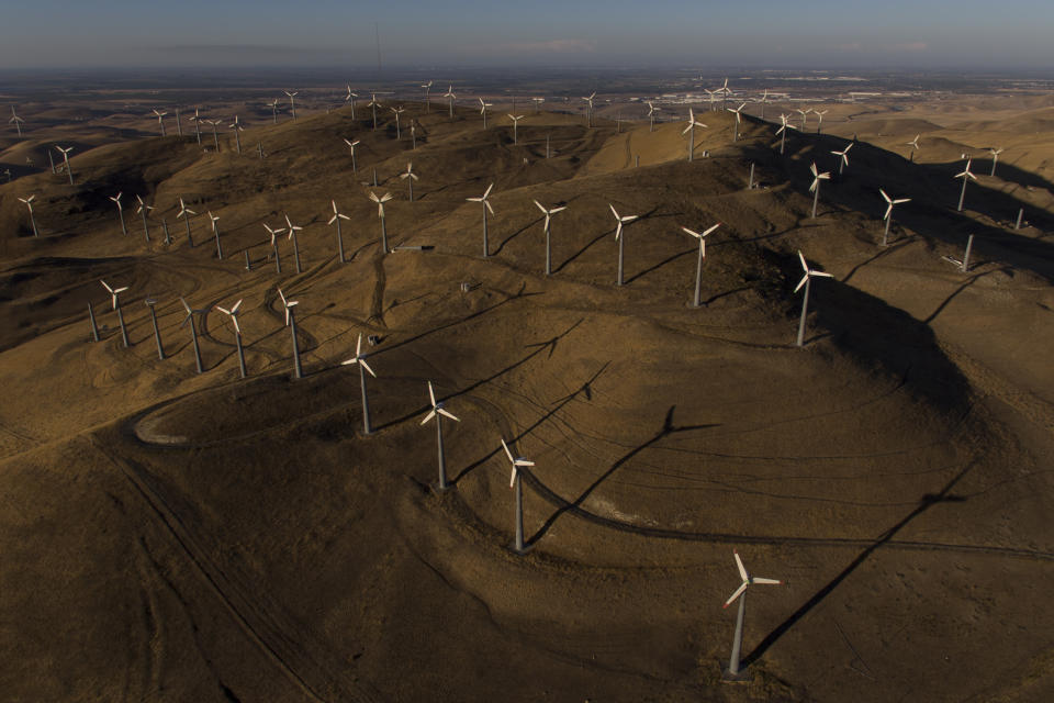 Wind turbines work in Livermore, Calif., Wednesday, Aug. 10, 2022. Congress is poised to pass a transformative climate change bill on Friday, Aug. 12. The crux of the long-delayed bill is to use incentives to accelerate the expansion of clean energy such as wind and solar power, speeding the transition away from the oil, coal and gas that largely cause climate change. (AP Photo/Godofredo A. Vásquez)