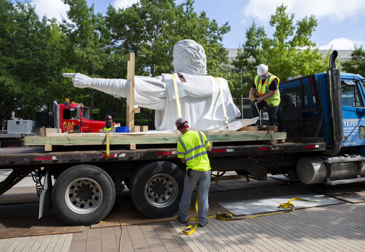 The statue head and upper body of Christopher Columbus sits on the back of a flatbed trailer as a construction crew removes the statue from the main campus of Columbus State Community College in Columbus, Ohio on Friday, June 19, 2020.