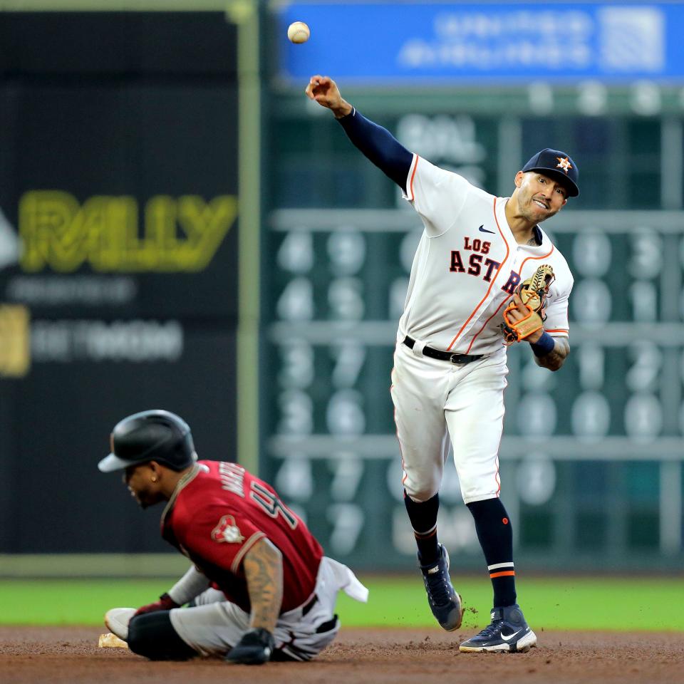 Sep 19, 2021; Houston, Texas, USA; Houston Astros shortstop Carlos Correa (1) throws the ball to first base to complete a double play against Arizona Diamondbacks player Ketel Marte (4) during the seventh inning at Minute Maid Park. Mandatory Credit: Erik Williams-USA TODAY Sports