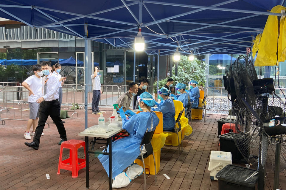 Medical workers in protective suits collect swabs at a nucleic acid testing site at the Software Park in Nanshan district, following the coronavirus disease (COVID-19) outbreak in Shenzhen, Guangdong province, China September 2, 2022. REUTERS/David Kirton