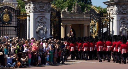 Guardsmen march past onlookers into Buckingham Palace during the Changing of the Guard in London in July 2012. The decision to publish photos of Prince William's wife Catherine topless has incensed the royal family, whose lawyers have obtained a civil injunction and sought criminal charges in Paris in a bid to curb their spreading