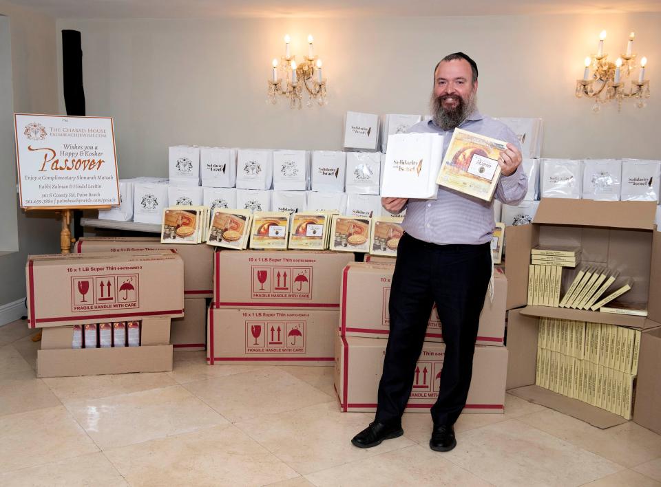 Rabbi Zalman Levitin of The Chabad House is seen on Friday with some of the 4,000 packages of matzo and Passover handbooks that will be distributed to members of the community for Passover, which also is called Pesach.