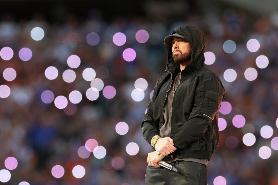 Eminem stands with a microphone in hand during the Super Bowl half time show