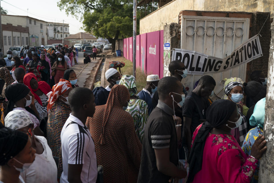 People line up to cast their ballot for Gambia's presidential elections, in Banjul, Gambia, Saturday, Dec. 4, 2021. Lines of voters formed outside polling stations in Gambia’s capital as the nation holds a presidential election. The election on Saturday is the first in decades without former dictator Yahya Jammeh as a candidate. (AP Photo/Leo Correa)