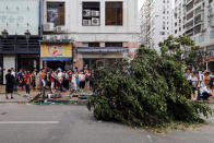 <p>Tourists from China lineup outside a jewelry shop where a tree was uprooted by strong winds from Typhoon Hato in Macau, China, Aug. 24, 2017. (Photo: Tyrone Siu/Reuters) </p>