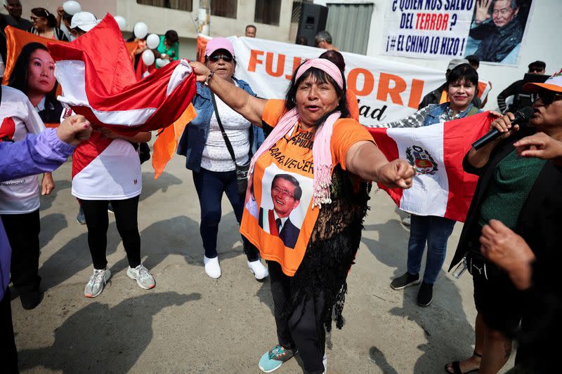 FILE PHOTO: People protest outside the prison where Peru's former President Alberto Fujimori is being held, in Lima