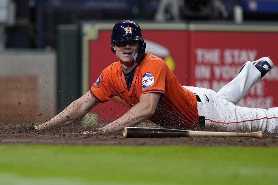 Houston Astros' Jake Meyers scores on a squeeze bunt by Jose Altuve during the seventh inning of a baseball game against the Seattle Mariners Friday, May 3, 2024, in Houston. (AP Photo/Kevin M. Cox)