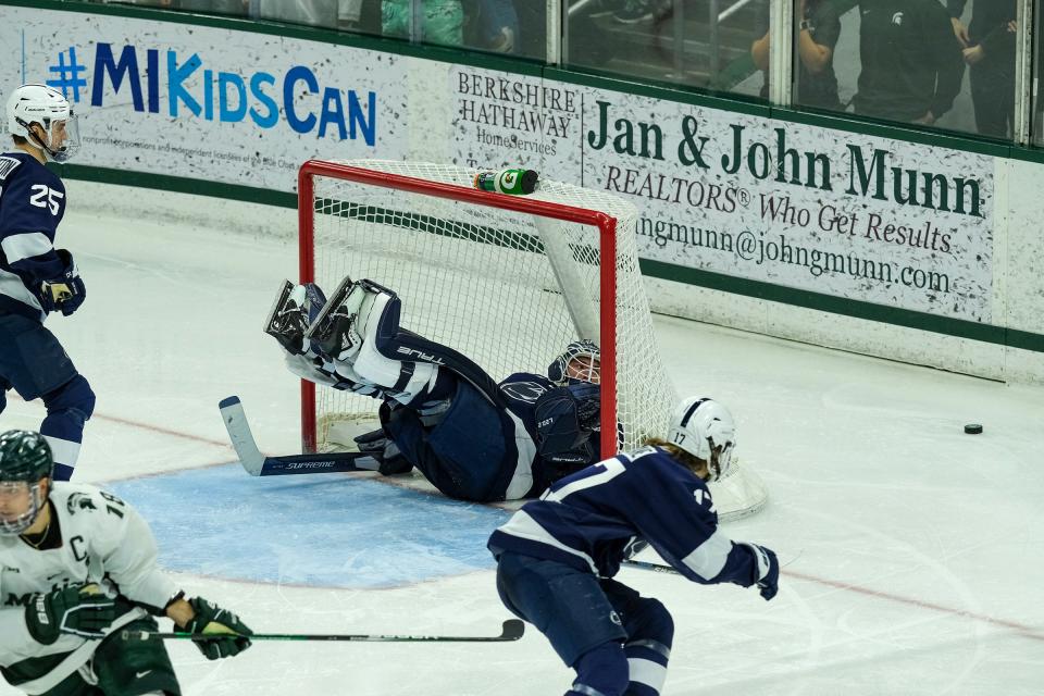 Penn State goaltender Liam Souliere (31) falls into the net while keeping his eye on the puck against Michigan State Saturday, Jan. 14, 2023.