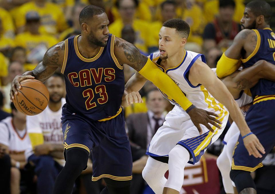 In this June 2, 2016, photo, former Cavaliers forward LeBron James (23) looks to dribble against Golden State Warriors guard Stephen Curry during the first half of Game 1 of the NBA Finals.