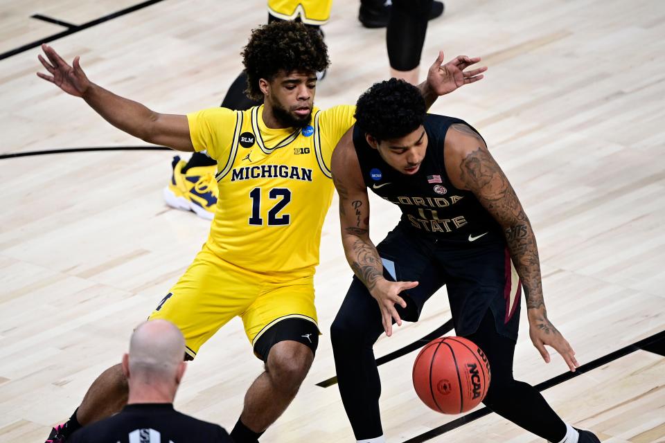 Florida State Seminoles guard RayQuan Evans (0) dribbles the ball against Michigan Wolverines guard Mike Smith (12) in the first half during the Sweet 16 of the 2021 NCAA tournament at Bankers Life Fieldhouse on March 28, 2021.