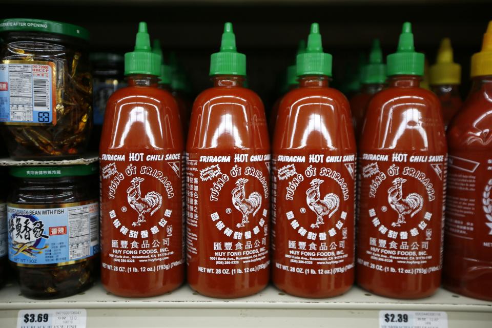 Bottles of Sriracha hot chili sauce, made by Huy Fong Foods, are seen on a supermarket shelf in San Gabriel, California October 30, 2013. REUTERS/Lucy Nicholson (UNITED STATES - Tags: BUSINESS FOOD)