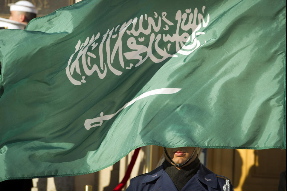 FILE - In this March 22, 2018 file photo, an Honor Guard member is covered by the flag of Saudi Arabia as Defense Secretary Jim Mattis welcomes Saudi Crown Prince Mohammed bin Salman to the Pentagon with an Honor Cordon, in Washington Saudi Arabia’s Interior Ministry said Tuesday, April 23, 2019, that 37 Saudi citizens have been beheaded in a mass execution that took place across various regions of the country. Saudi King Salman ratified the executions for terrorism-related crimes by royal decree. (AP Photo/Cliff Owen, File)