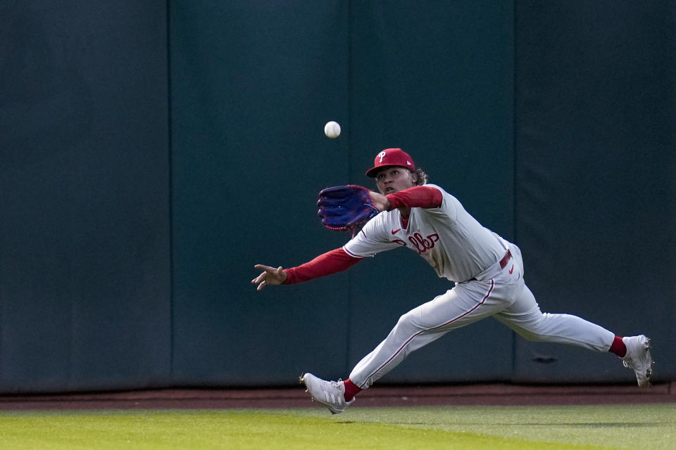 Philadelphia Phillies center fielder Cristian Pache catches a line drive by Oakland Athletics' Aledmys Díaz during the seventh inning of a baseball game in Oakland, Calif., Friday, June 16, 2023. (AP Photo/Godofredo A. Vásquez)