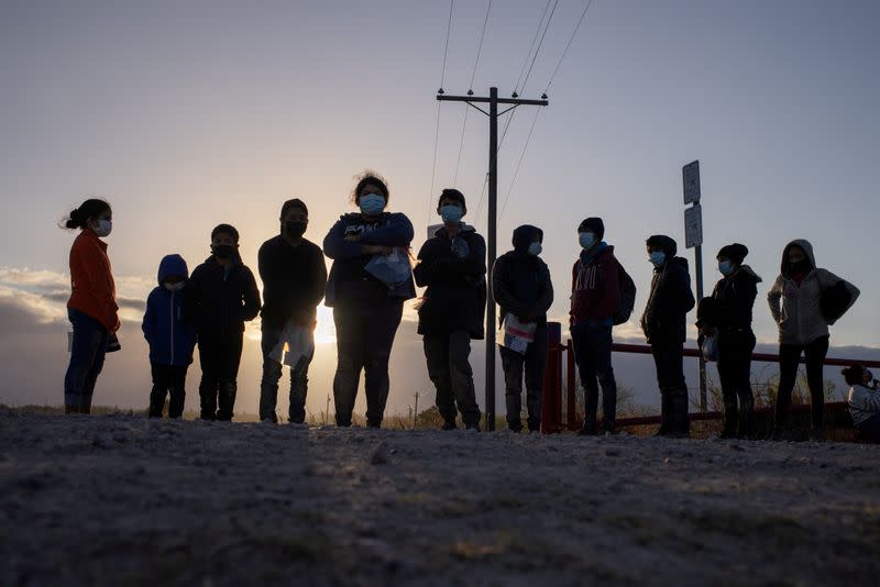 FILE PHOTO: Migrants from Central America await transport after crossing into the U.S. from Mexico on a raft in Penitas, Texas