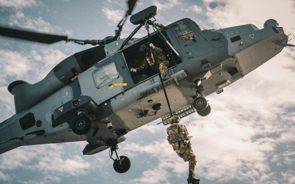 A Royal Marine fast roping from a Wildcat helicopter whilst on exercise in Cyprus, operating from the Amphibious Flag Ship, HMS Albion.  - LPhot Barry Swainsbury/Royal Navy