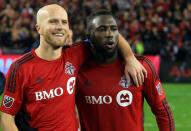 <p>Michael Bradley #4 of Toronto FC celebrates with Jozy Altidore #17 at the final whistle following the MLS Eastern Conference Final, Leg 2 game against Montreal Impact at BMO Field on November 30, 2016 in Toronto, Ontario, Canada. (Photo by Vaughn Ridley/Getty Images) </p>