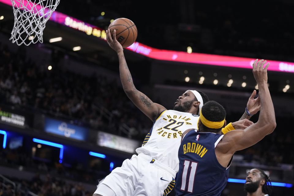 Indiana Pacers' Isaiah Jackson (22) puts up a shot against Denver Nuggets' Bruce Brown (11) during the second half of an NBA basketball game, Wednesday, Nov. 9, 2022, in Indianapolis. Denver won 122-119. (AP Photo/Darron Cummings)