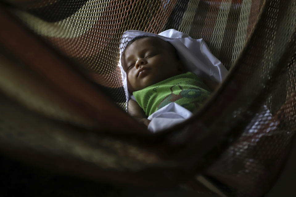 Oneida Santos, the 4-month-old daughter of Esmeralda Dominguez and Sergio Santos, sleeps in a hammock in the Sisiguayo community in Jiquilisco, in the Bajo Lempa region of El Salvador, Thursday, May 12, 2022. Her parents are among the thousands arrested in the past eight weeks during anti-gang operations since the Congress granted President Nayib Bukele a state of emergency declaration suspending some civil liberties. (AP Photo/Salvador Melendez)