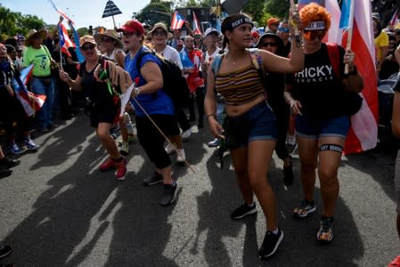 Demonstrators chant and wave Puerto Rican flags during the national strike calling for the resignation of Governor Ricardo Rossello, in San Juan