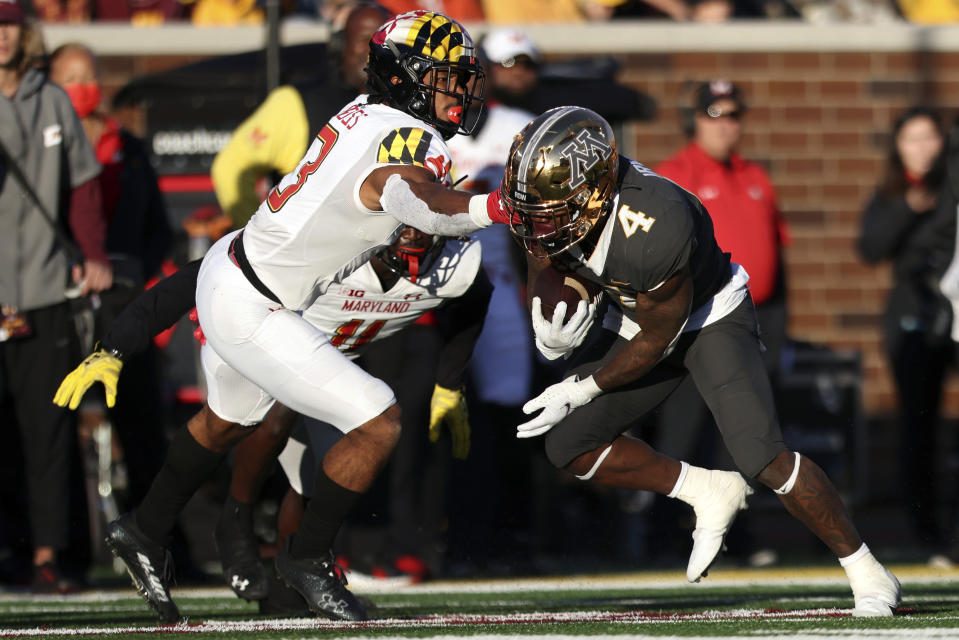 Minnesota running back Mar'Keise Irving (4) carries the ball against Maryland defensive back Nick Cross (3) during the second half of an NCAA college football game Saturday, Oct. 23, 2021, in Minneapolis. (AP Photo/Stacy Bengs)