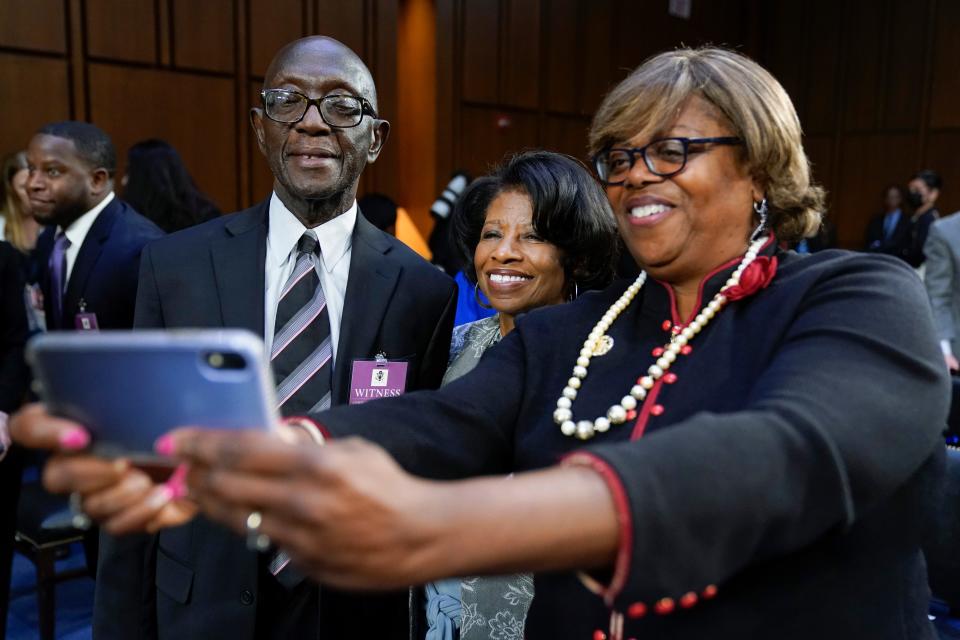 Supreme Court nominee Ketanji Brown Jackson's parents Johnny Brown, left, and and Ellery Brown, center, pose for a photo during a break in a Senate Judiciary Committee confirmation hearing on Capitol Hill in Washington, Tuesday, March 22, 2022.