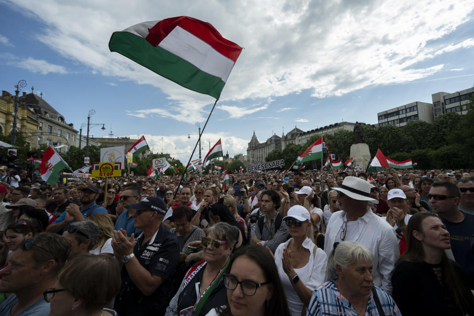 People wave the Hungarian national flag during Péter Magyar's speech at a campaign rally in the rural city of Debrecen, Hungary, on Sunday, May 5, 2024. Magyar, whose TISZA party is running in European Union elections, has managed to mobilize large crowds of supporters on a campaign tour of Hungary's heartland, a rarity for an Orbán opponent. (AP Photo/Denes Erdos)