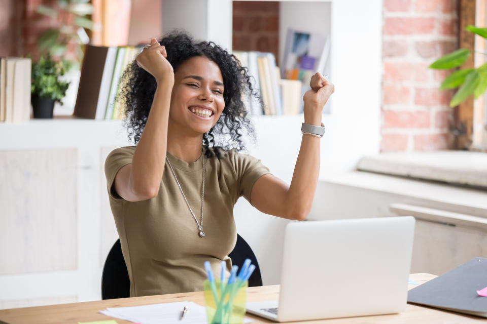 Woman cheering at computer