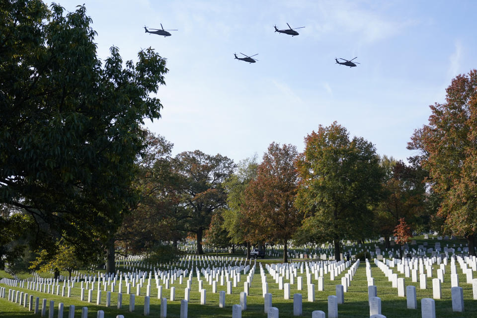 FILE - U.S. Army Blackhawk helicopters perform a flyover as part of a ceremony to commemorate the 100th anniversary of the Tomb of the Unknown Soldier at Arlington National Cemetery, Nov. 11, 2021, in Arlington, Va. A trial underway in federal court will decide whether the U.S. government must pay up to $21 million to compensate a Virginia county for a parcel of land taken to expand Arlington National Cemetery. The cemetery expansion project has already begun work and is expected to extend the cemetery’s life by nearly 20 years, until 2060. (AP Photo/Patrick Semansky, File)