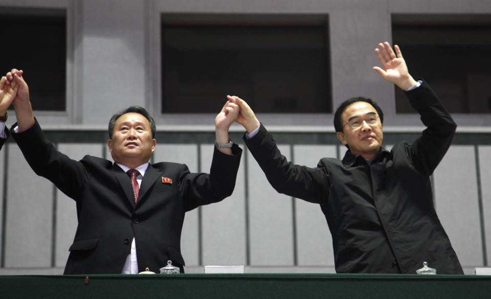 FILE - In this Oct. 5, 2018, file photo, Ri Son Gwon, left, then chairman of the North Korean agency that handles inter-Korean affairs, and South Korean Unification Minister Cho Myoung-gyon wave during an event for national reunification marking the 11th anniversary of the publication of the Oct. 4 declaration at the May Day Stadium in Pyongyang. Ri on Wednesday, June 23, 2021, reiterated Noth Korea's stance that it has no immediate intention to resume stalled nuclear talks with the United States, dismissing hopes expressed by U.S. and South Korean officials for a quick resumption of negotiations. (AP Photo/Jon Chol Jin, File)