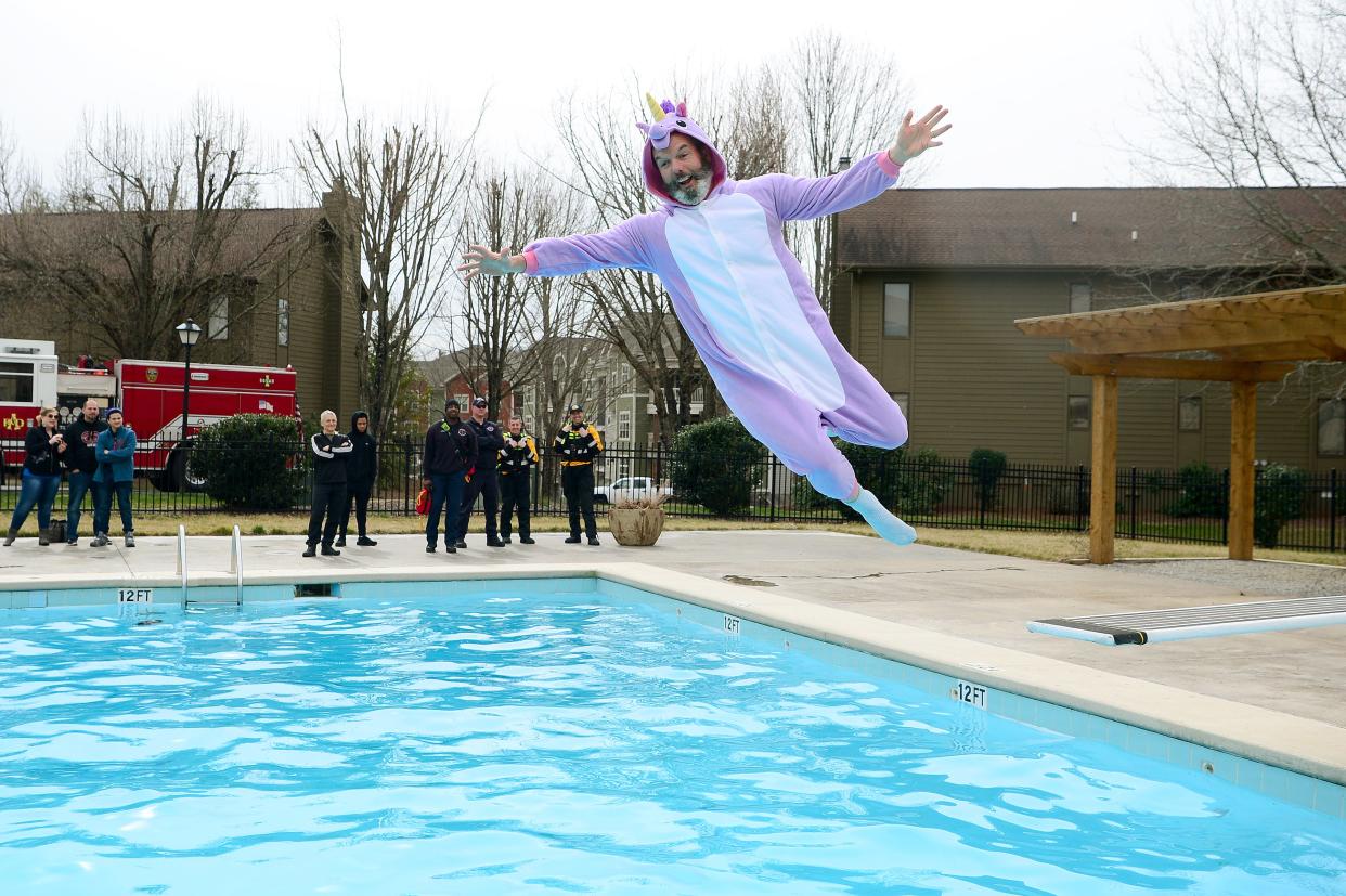 Asheville Citizen-Times "Answer Man" John Boyle dons a unicorn costume as he leaps into the pool at the Asheville Racquet Club during the 9th annual Polar Plunge benefitting Meals on Wheels on Saturday, Feb. 18, 2017. Boyle has been wearing strange costumes and jumping into chilly water at the event for four years. 