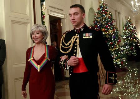 The 2015 Kennedy Center Honoree Rita Moreno (L) arrives at a reception at the White House in Washington December 6, 2015. REUTERS/Yuri Gripas