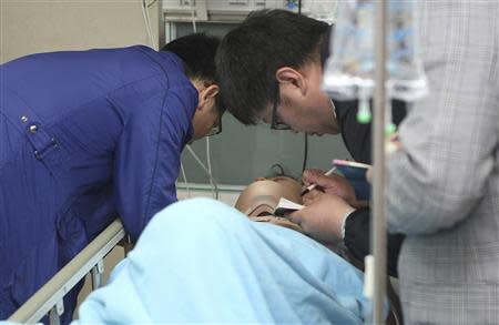 A doctor exams a North Korean crew member from a Mongolian-flagged cargo ship that sank in the sea off Yeosu, at a hospital on Jeju island April 4, 2014. REUTERS/Byun Ji-cheol/Yonhap
