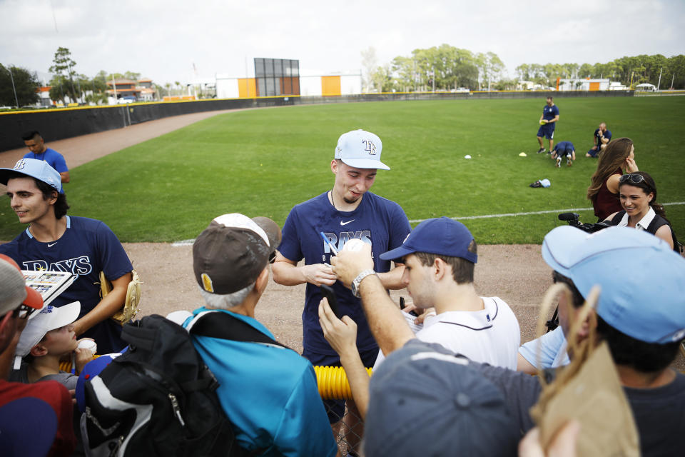 Tampa Bay Rays pitcher Blake Snell signs autographs for fans during spring baseball practice Thursday, Feb. 13, 2020 in Port Charlotte, Fla. (Octavio Jones/Tampa Bay Times via AP)