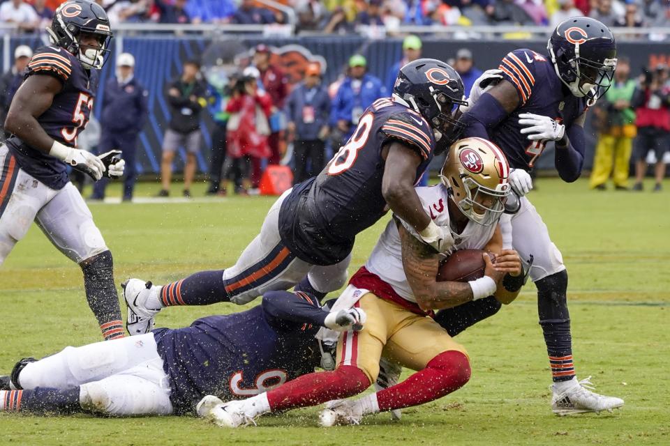 San Francisco 49ers' Trey Lance is stopped by Chicago Bears' Roquan Smith and Dominique Robinson during the first half of an NFL football game Sunday, Sept. 11, 2022, in Chicago. (AP Photo/Charles Rex Arbogast)
