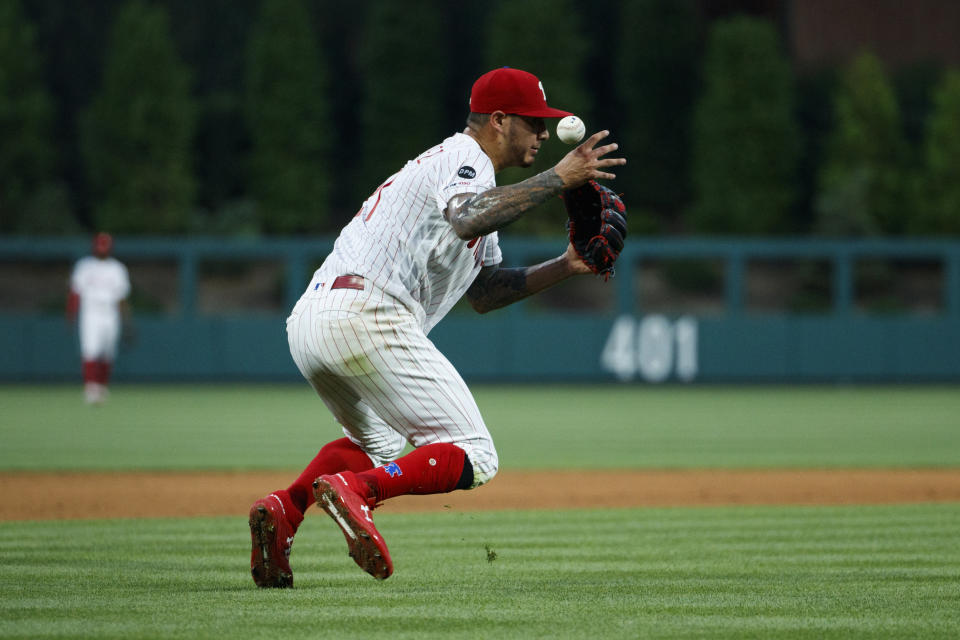 Philadelphia Phillies starting pitcher Vince Velasquez commits a fielding error allowing Los Angeles Dodgers' Justin Turner to reach first base during the fourth inning of a baseball game, Tuesday, July 16, 2019, in Philadelphia. (AP Photo/Matt Slocum)