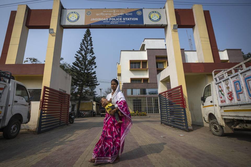 Nureja Khatun, 19, holding her 6 months old baby, waits outside a police station to catch the glimpse of her husband Akbor Ali, in Morigaon district of Indian northeastern state of Assam, Saturday, Feb. 11, 2023. Khatun's husband is one among more than 3,000 men, including Hindu and Muslim priests, who were arrested nearly two weeks ago in the northeastern state of Assam under a wide crackdown on illegal child marriages involving girls under the age of 18. (AP Photo/Anupam Nath)