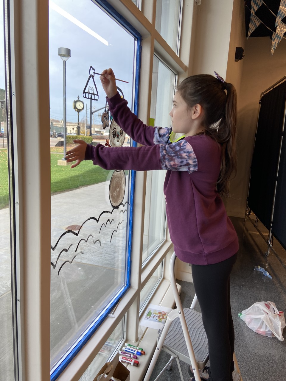Lily Krebs, a sixth-grade homeschooler, is seen painting a holiday scene.